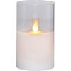 Candle white wax with flickering flame